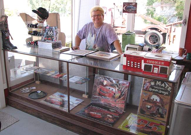 Melba Rigg with scrap book and Radiator Springs memorabilia