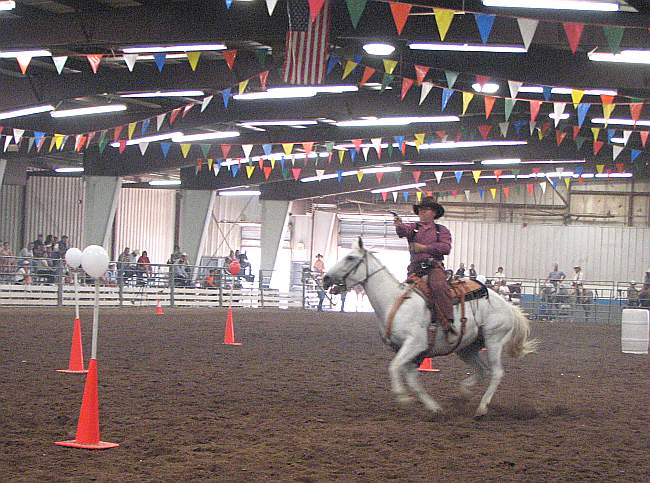 Cowboy mounting shooting competition at Kansas State Fair