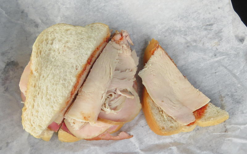 Sliced turkey and ham sandwich on bread